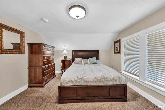 carpeted bedroom featuring lofted ceiling