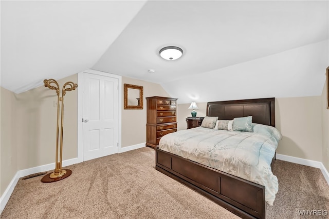 carpeted bedroom with vaulted ceiling