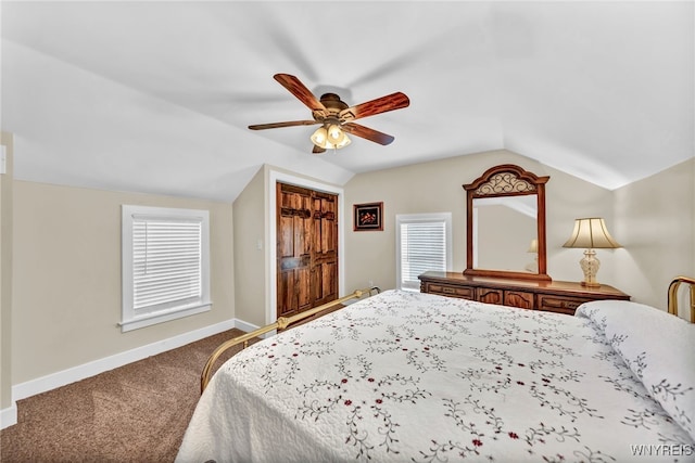 carpeted bedroom with lofted ceiling, ceiling fan, and multiple windows