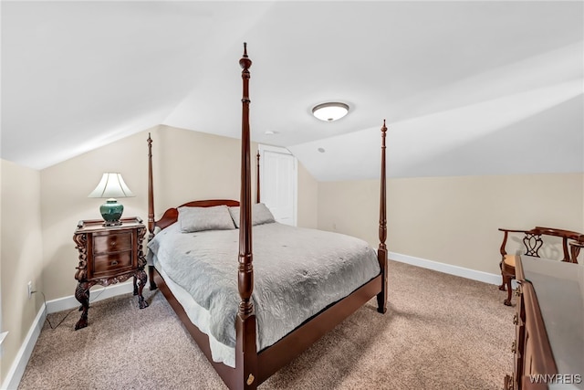 carpeted bedroom with vaulted ceiling