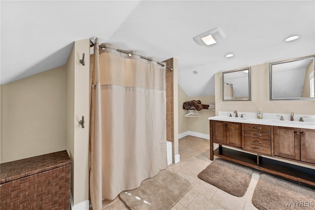 bathroom featuring walk in shower, vanity, and tile patterned flooring