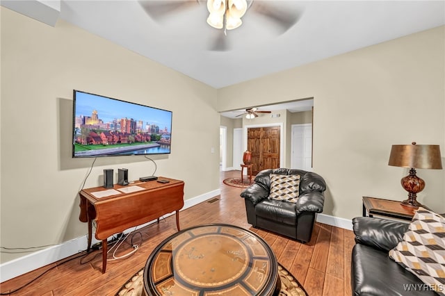 living room with ceiling fan and hardwood / wood-style flooring