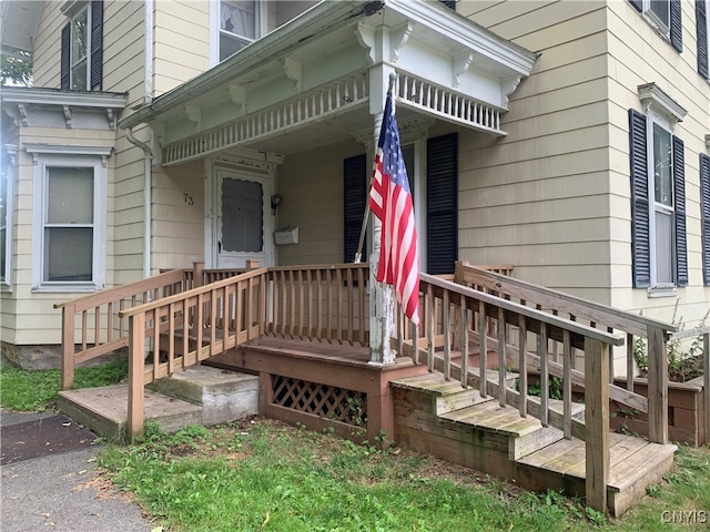 view of exterior entry featuring a deck