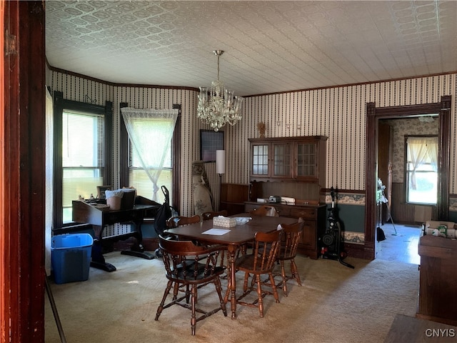 carpeted dining area with a chandelier