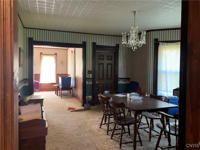 carpeted dining space featuring a textured ceiling and a chandelier