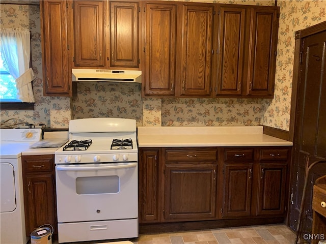 kitchen with washer / dryer and gas range gas stove