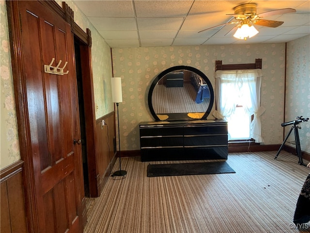 miscellaneous room featuring carpet, ceiling fan, and a paneled ceiling