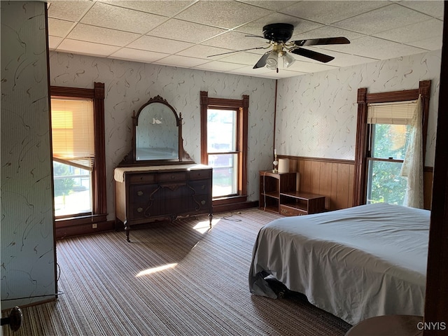 unfurnished bedroom featuring ceiling fan, carpet floors, and a paneled ceiling