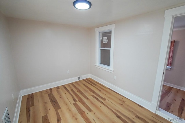 spare room featuring wood-type flooring