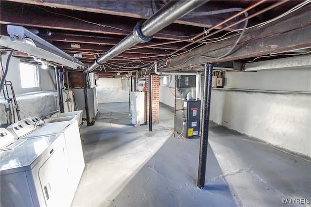 basement with separate washer and dryer, gas water heater, heating unit, and sink