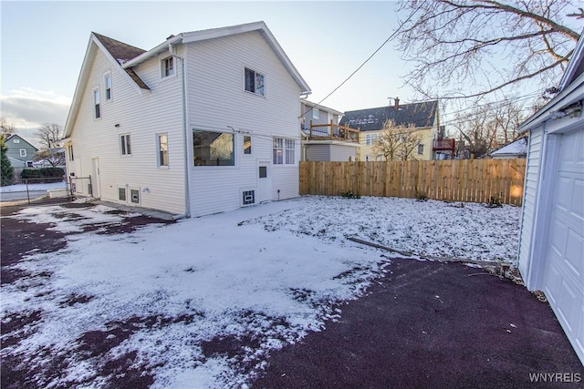 view of snow covered rear of property