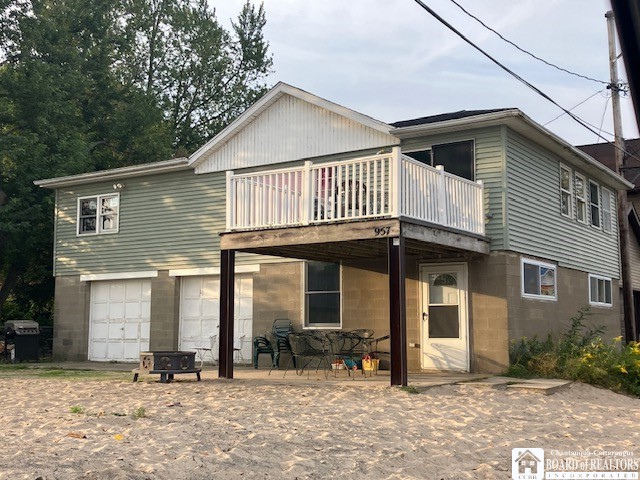 rear view of house with a garage