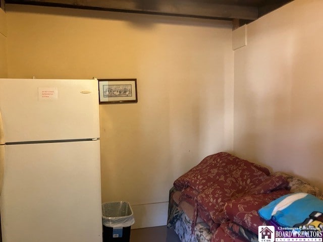 bedroom featuring white fridge