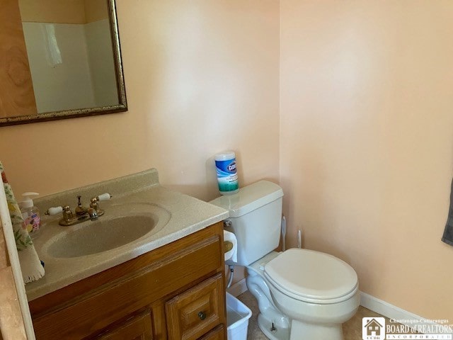 bathroom with tile patterned floors, vanity, and toilet