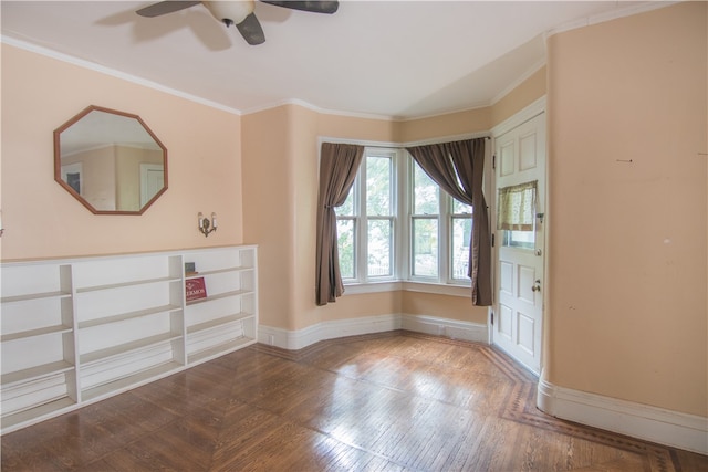 interior space with wood-type flooring, ornamental molding, and ceiling fan