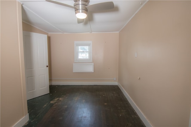 spare room featuring vaulted ceiling, dark hardwood / wood-style floors, and ceiling fan