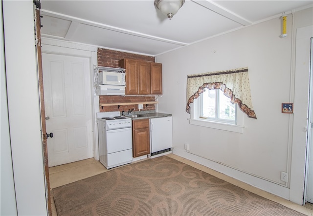 kitchen featuring white appliances and sink