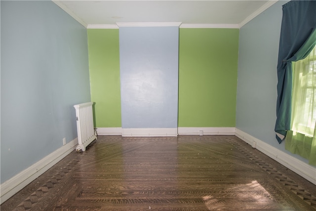 spare room with ornamental molding and radiator heating unit