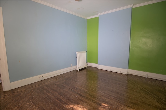 spare room with radiator, crown molding, and dark wood-type flooring