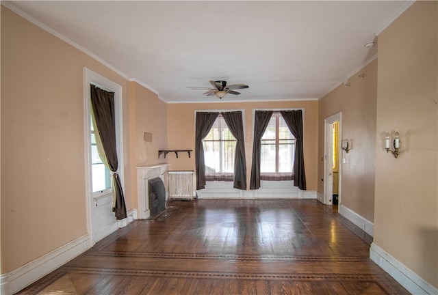 unfurnished living room featuring ceiling fan, radiator, crown molding, and dark wood-type flooring