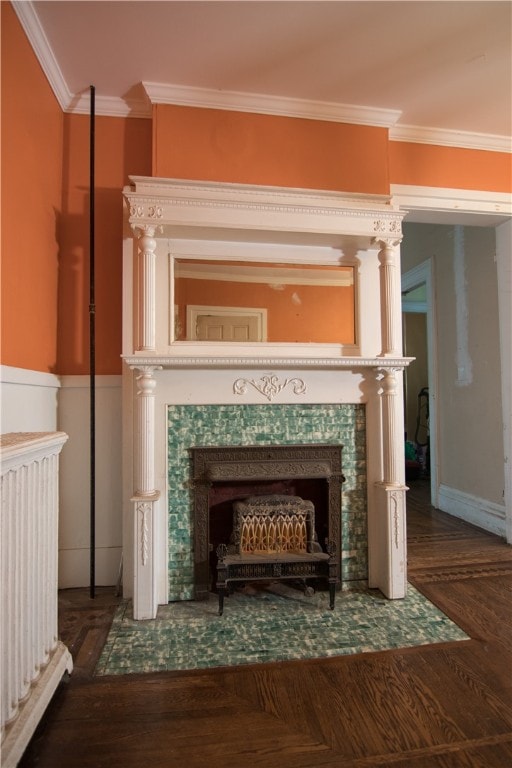 details with hardwood / wood-style floors, ornamental molding, and a tiled fireplace