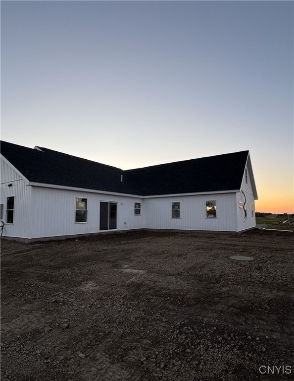 view of back house at dusk