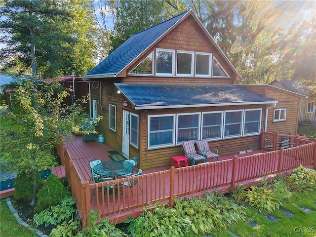 back of property with a wooden deck