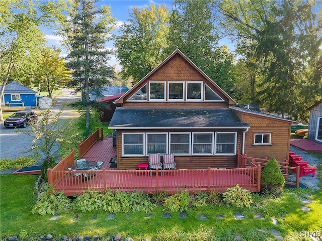 back of property featuring a wooden deck