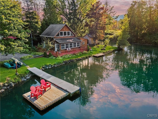 view of dock featuring a yard and a water view