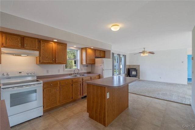 kitchen featuring ceiling fan, a center island, white appliances, and sink