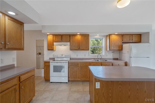 kitchen with sink, a kitchen island, and white appliances