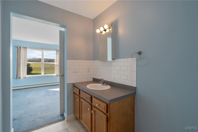 bathroom with baseboard heating, backsplash, and vanity