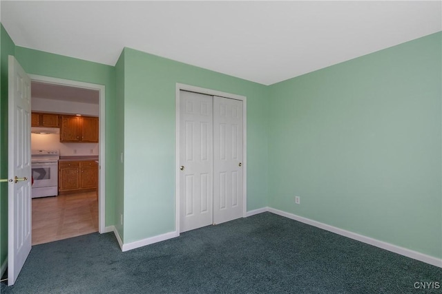 unfurnished bedroom with dark colored carpet and a closet