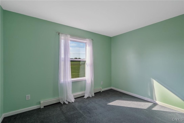 carpeted spare room with a baseboard heating unit