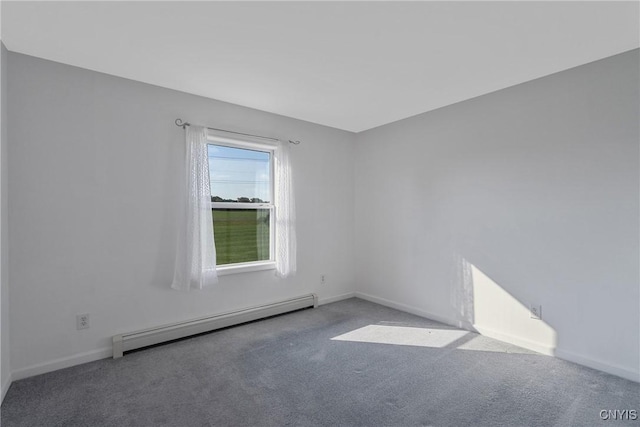 carpeted empty room featuring a baseboard heating unit