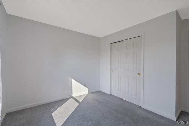 unfurnished bedroom with a closet and carpet