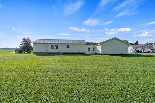 rear view of house with a lawn