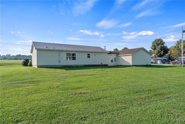 rear view of property with a lawn