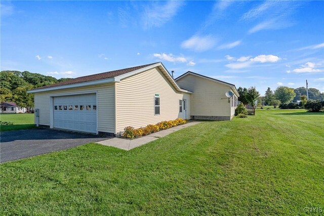 view of home's exterior with a lawn and a garage