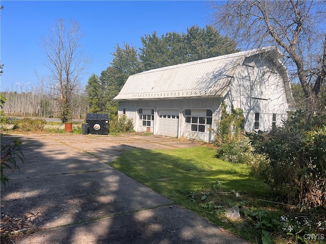 view of front of house with a garage and a front lawn