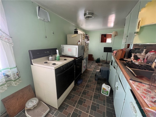 kitchen with white appliances, sink, and wooden counters