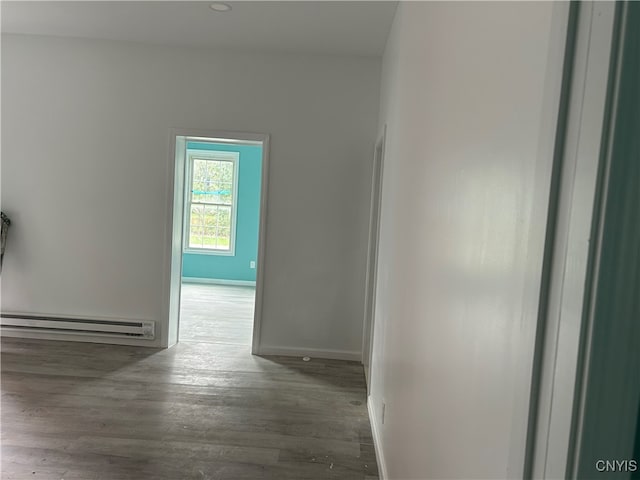 hall featuring a baseboard radiator and dark hardwood / wood-style floors