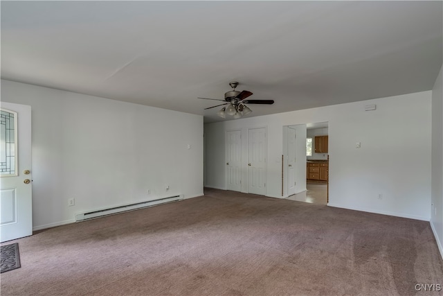 spare room with light carpet, baseboard heating, and ceiling fan