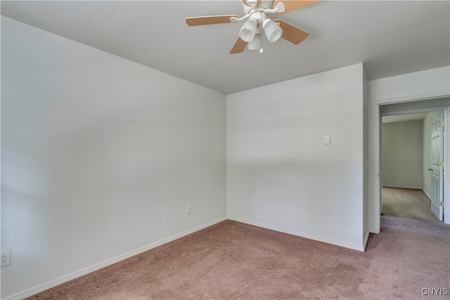 spare room with ceiling fan and light colored carpet