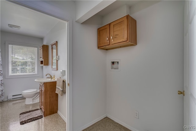 interior space featuring a baseboard heating unit, washer hookup, and sink