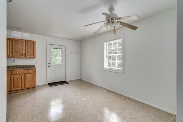 interior space with ceiling fan