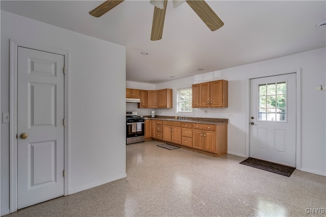 kitchen with ceiling fan, stainless steel range oven, and sink