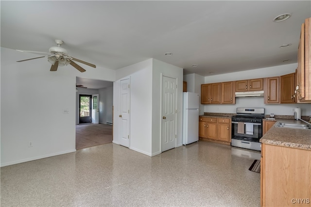 kitchen with ceiling fan, white refrigerator, stainless steel gas range oven, and sink