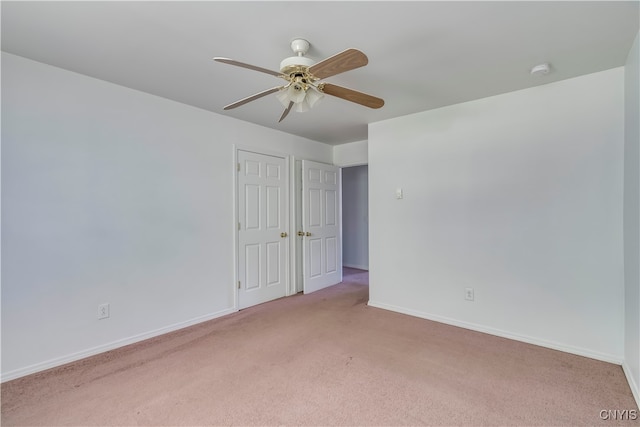 unfurnished bedroom with ceiling fan and light colored carpet