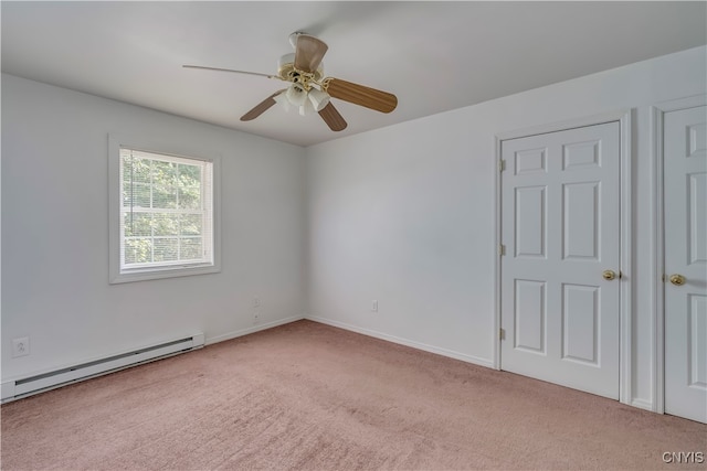 carpeted empty room featuring ceiling fan and a baseboard radiator